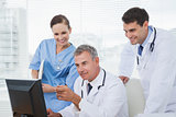 Doctors and surgeon working together on computer