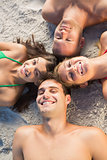 Overhead of cheerful friends lying together in a circle