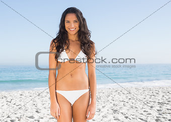 Pretty brunette posing in white bikini