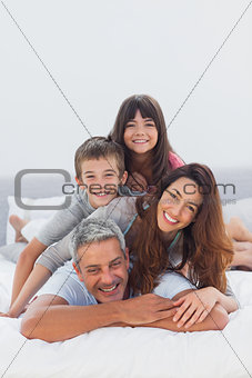 Parents with their children lying on bed