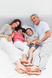 Family lying on bed