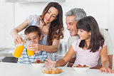Family eating breakfast in kitchen together