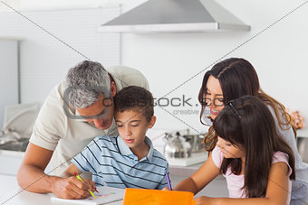 Family drawing together in kitchen