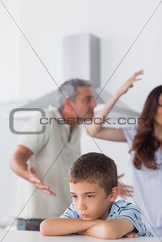 Couple having dispute in front of their upset son