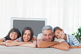 Cute family in sitting room smiling at camera