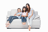 Mother with their children sitting on sofa