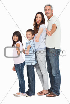 Portrait of a cute family in single file doing thumbs up at camera