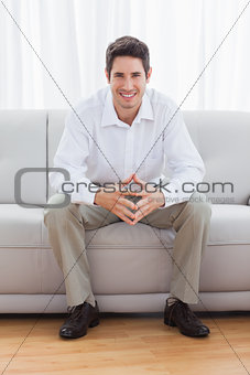 Young man sitting on sofa