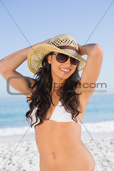 Happy attractive brunette with straw hat and sunglasses