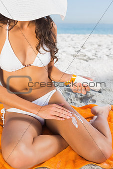 Close up of woman applying sun cream