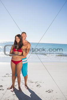 Cute couple embracing one another while looking at camera