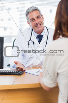 Happy doctor talking with his patient