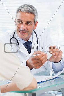 Smiling doctor listening to his patient