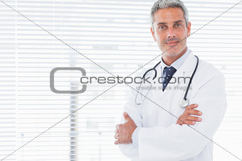 Smiling doctor crossing his arms