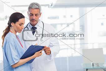 Nurse and doctor looking a file