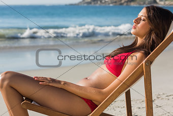Pretty woman relaxing on her deck chair