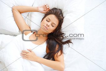 Beautiful girl sleeping in white bedding