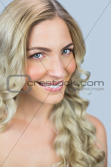 Cheerful natural blonde posing while looking at camera