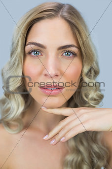 Beautiful natural blonde posing touching her face