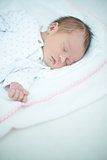 Close up of Sleeping Baby on White Bed