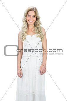 Gorgeous blond model in white dress posing