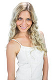 Smiling sensual model in white dress posing