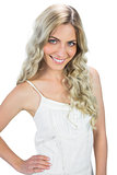 Cheerful sensual model in white dress posing