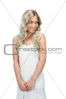 Reserved sensual model in white dress posing