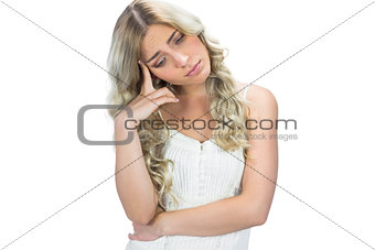 Sad seductive model in white dress posing