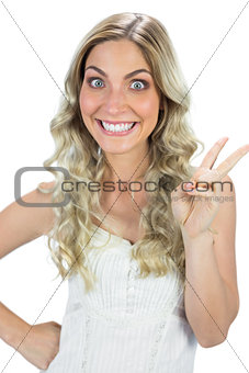 Funny blond model making peace and love sign