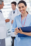 Doctor talking during a nurse smiling at camera
