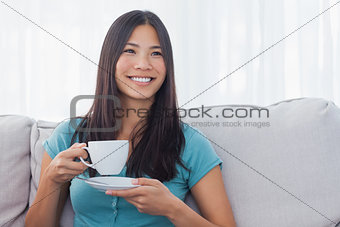 Young asian woman drinking cup of tea