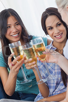 Cheerful friends enjoying white wine together
