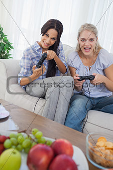 Laughing friends playing video games