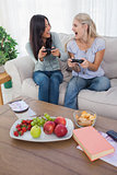 Cheerful friends playing video games and laughing