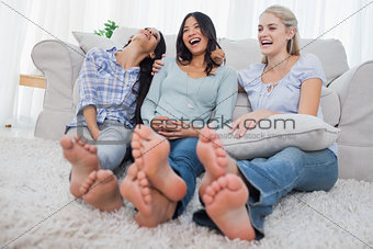 Friends relaxing on floor and laughing
