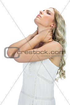 Thoughtful sensual blonde holding her neck