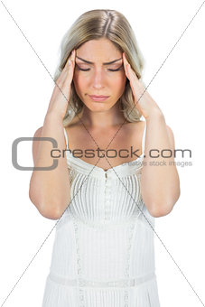 Sensual blonde suffering while having a headache