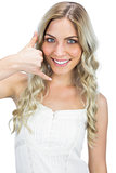 Attractive blue eyed model making phone call gesture