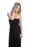 Relaxed attractive blonde wearing black dress posing