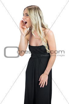 Attractive blonde wearing black dress screaming