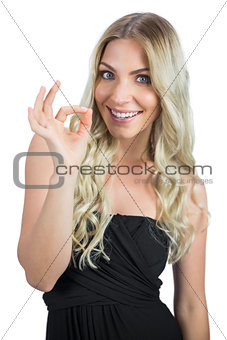 Cheerful gorgeous blonde in black dress gesturing
