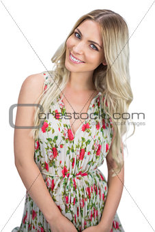 Cheerful attractive blonde wearing flowered dress posing