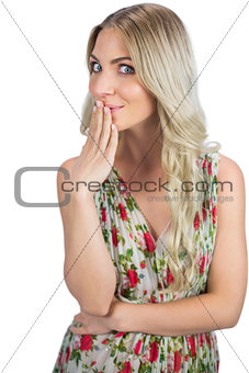 Seductive blond model  wearing flowered dress having secret