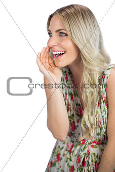 Seductive blonde wearing flowered dress telling secret