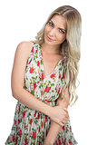 Relaxed seductive blonde wearing flowered dress posing