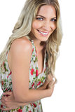 Smiling seductive blonde wearing flowered dress posing