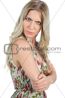 Serious seductive blonde wearing flowered dress posing