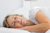 Peaceful blonde woman sleeping in bed