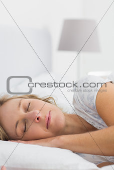 Blonde woman sleeping in bed